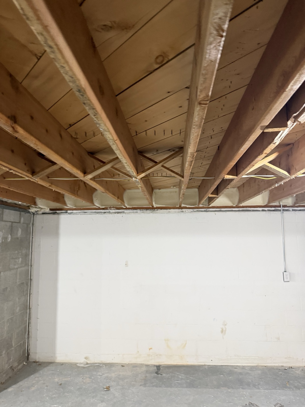The rim joist run, foamed end to end.