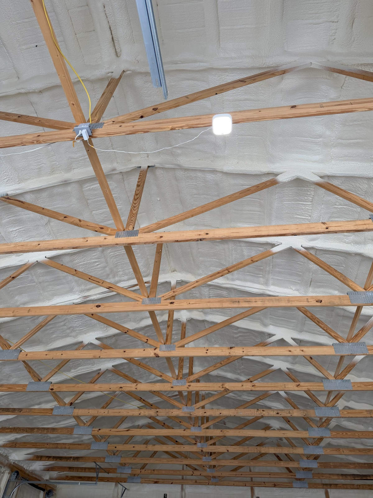 The roof foamed end to end above the trusses.